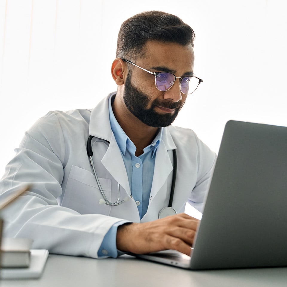 Male Doctor On Computer